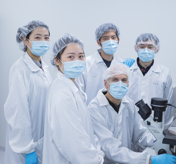 A group of people in lab coats posing for a photo.