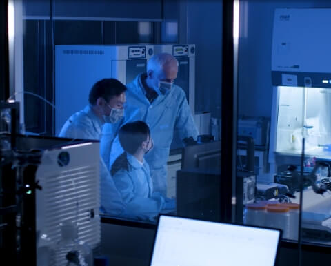 A group of people working in a laboratory at night.